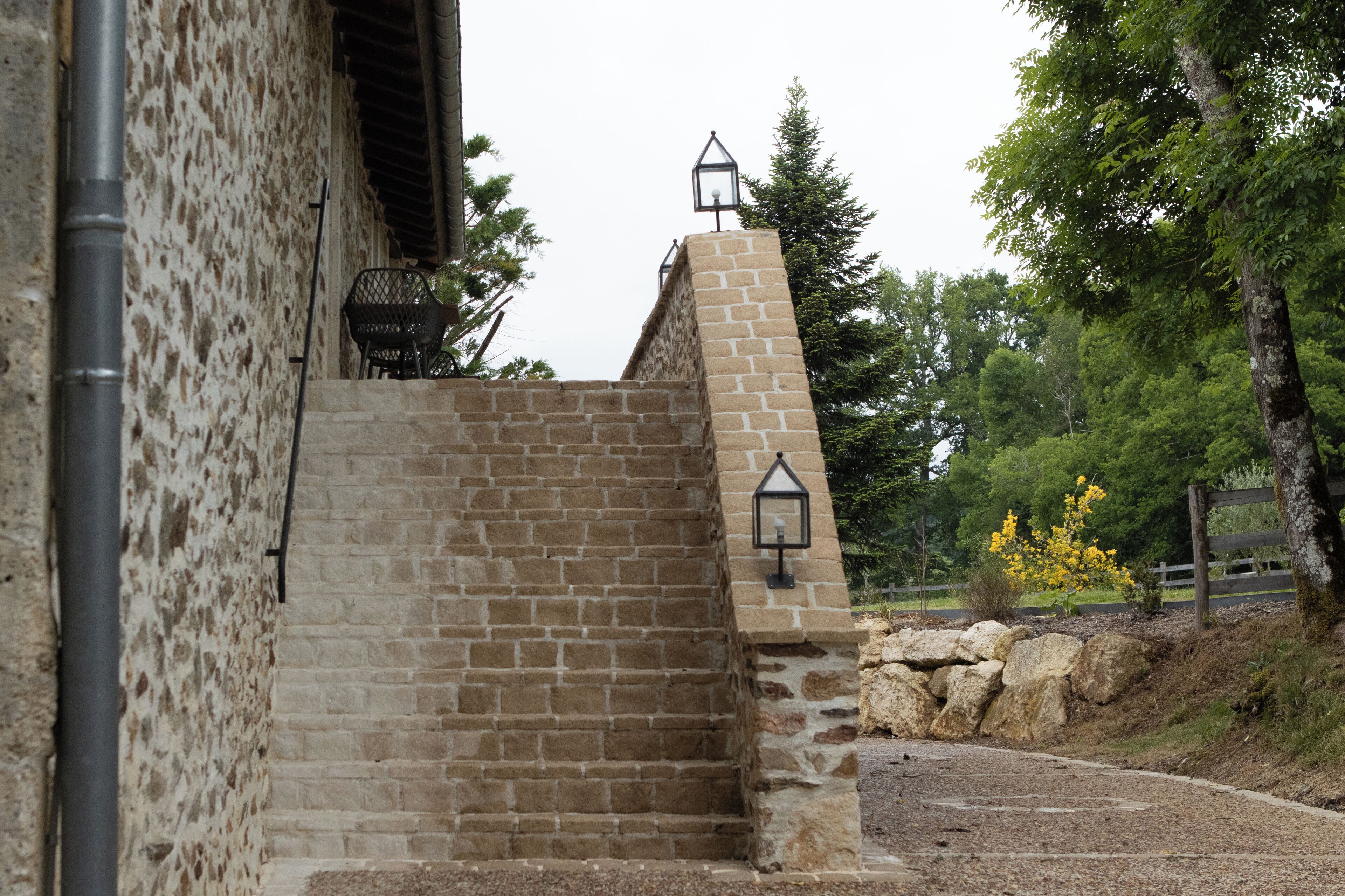 A stone staircase leading to a building with a lantern on top.