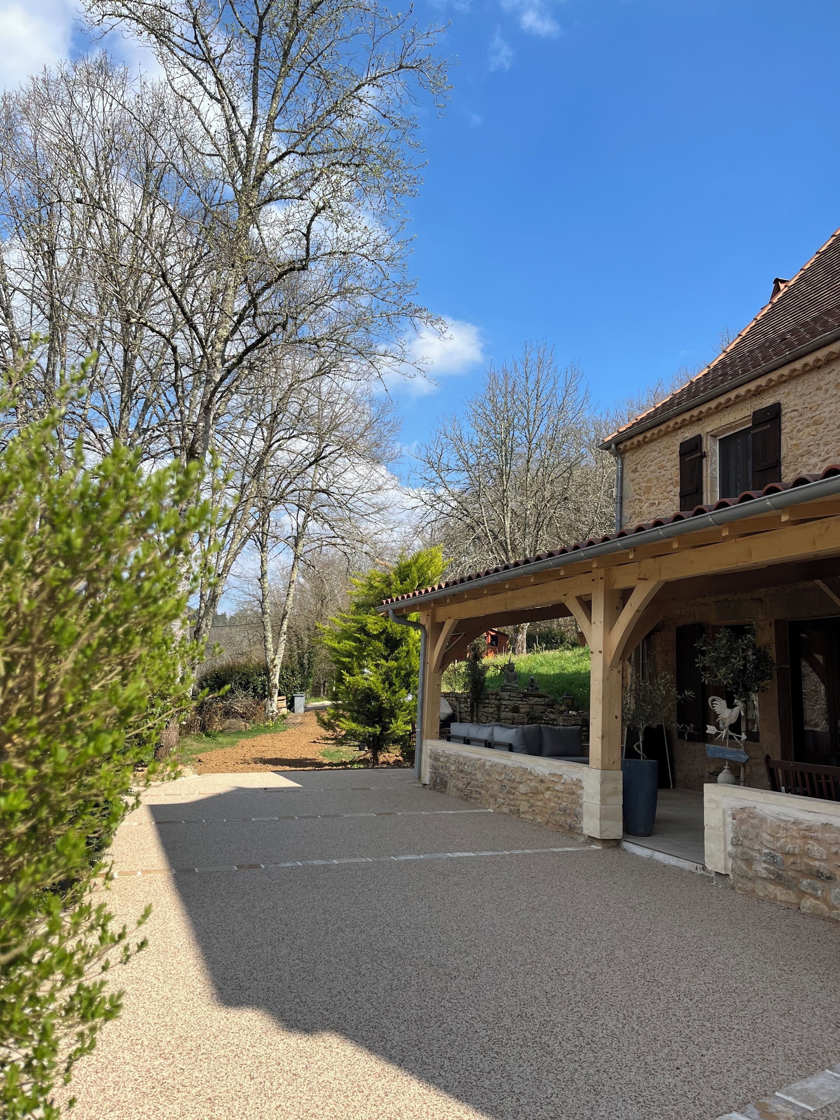 A stone building with a covered patio and outdoor seating area.