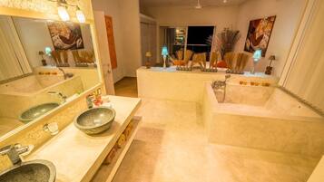 A modern bathroom with two sinks, a bathtub, and a large mirror.