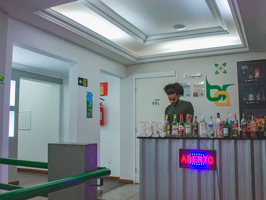 A bar area with a sign indicating it's open, a fire extinguisher, and a logo on the wall.