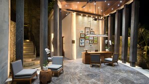 A lobby with a reception desk, seating area, and a staircase. - The Tamarind Resort Nusa Lembongan Bali (Lembongan Island)