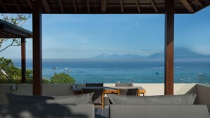 A terrace with a view of the sea and mountains, featuring outdoor furniture and a wooden pergola. - The Tamarind Resort Nusa Lembongan Bali (Lembongan Island)
