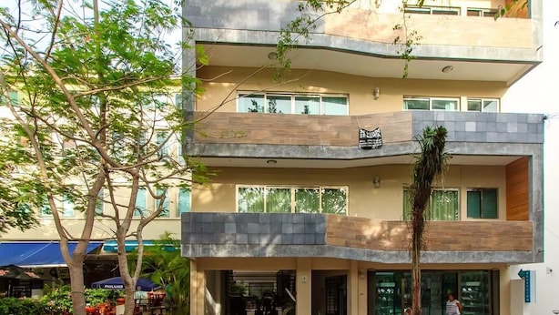 A multi-story building with a modern architectural design, featuring a ground-level entrance with a staircase leading to the upper floors. - Davinci By Vtpvacaciones (Playa del Carmen)