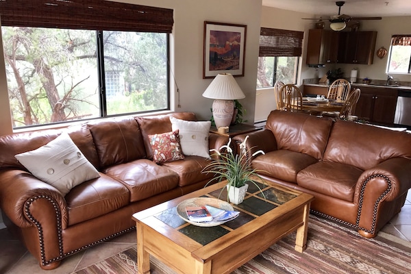 Open concept living room to kitchen and backyard.