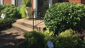 A brick building with a white awning, a number '1523' above the door, and a sign indicating 'Heritage Hills Security Corporation'.