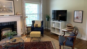 A living room with a fireplace, a television, and a comfortable seating area.