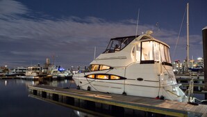 A yacht docked at a marina with a clear view of the water and other boats in the background. - Boston Harbor Yacht,  AC/Heat, Walk to North End WiFi (Boston)