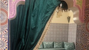 A traditional room with a green velvet canopy bed, patterned cushions, a wooden chair, and a small table with a yellow cloth. - Apartment/ flat - ESSAOUIRA (Essaouira)