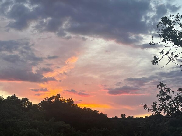 A sunset over a forested area with a cloudy sky. - Seafront rural house at Croatia island for families and large groups (Nečujam)