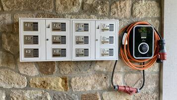 A wall-mounted electrical panel with multiple switches and a connected cable.