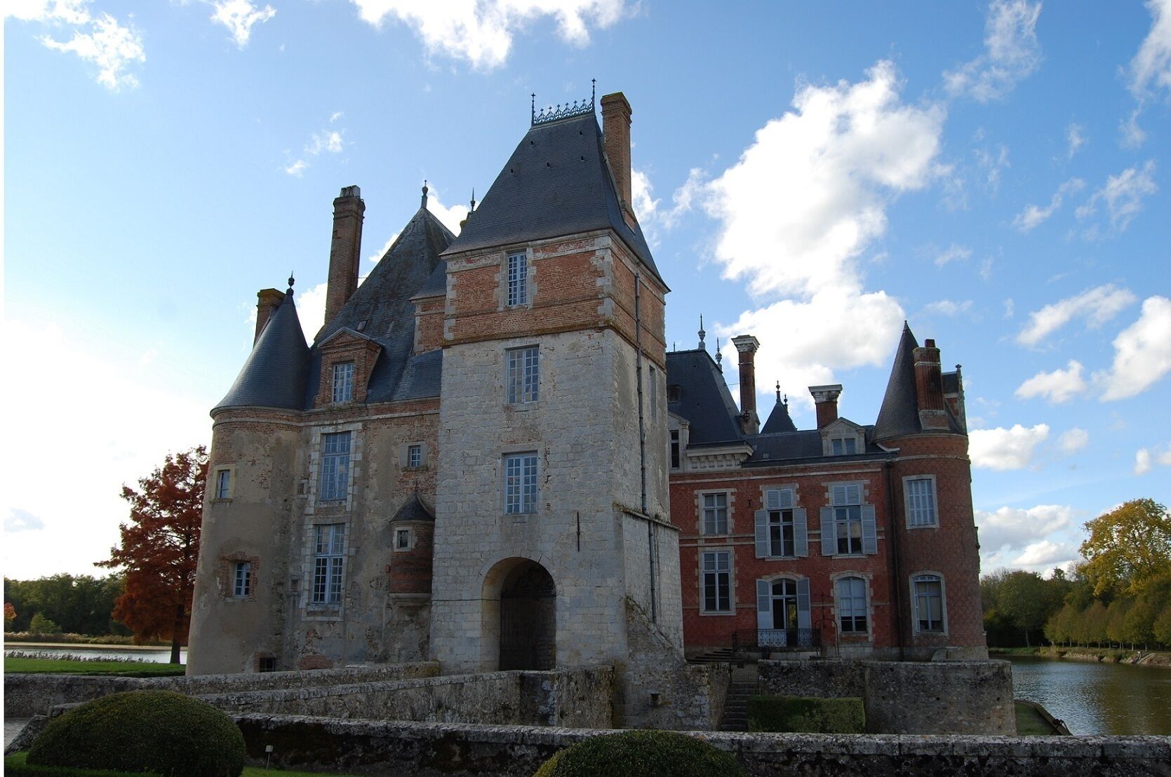 A historic building with multiple towers and a moat.