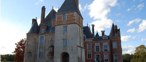 A historic building with multiple towers and a moat.