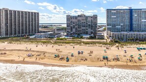 A beach with multiple high-rise buildings in the background. - Spacious Upgraded Oceanfront Gem, Great Views, Sleeps 6, Flexible Check-in Days (Ocean City)