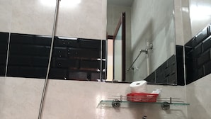 A bathroom with a shower, sink, and mirror. - Hong Ngoc Hotel (Ho Chi Minh City)