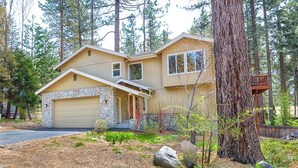 A two-story house with a stone facade, a garage, and a deck. - Make Memories in Marla Bay, Private Homeowners Beach, 8 Guests (Zephyr Cove)