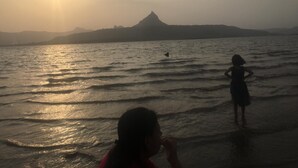 A beach scene with a mountain silhouette in the background. - The Bob house (Mawal)
