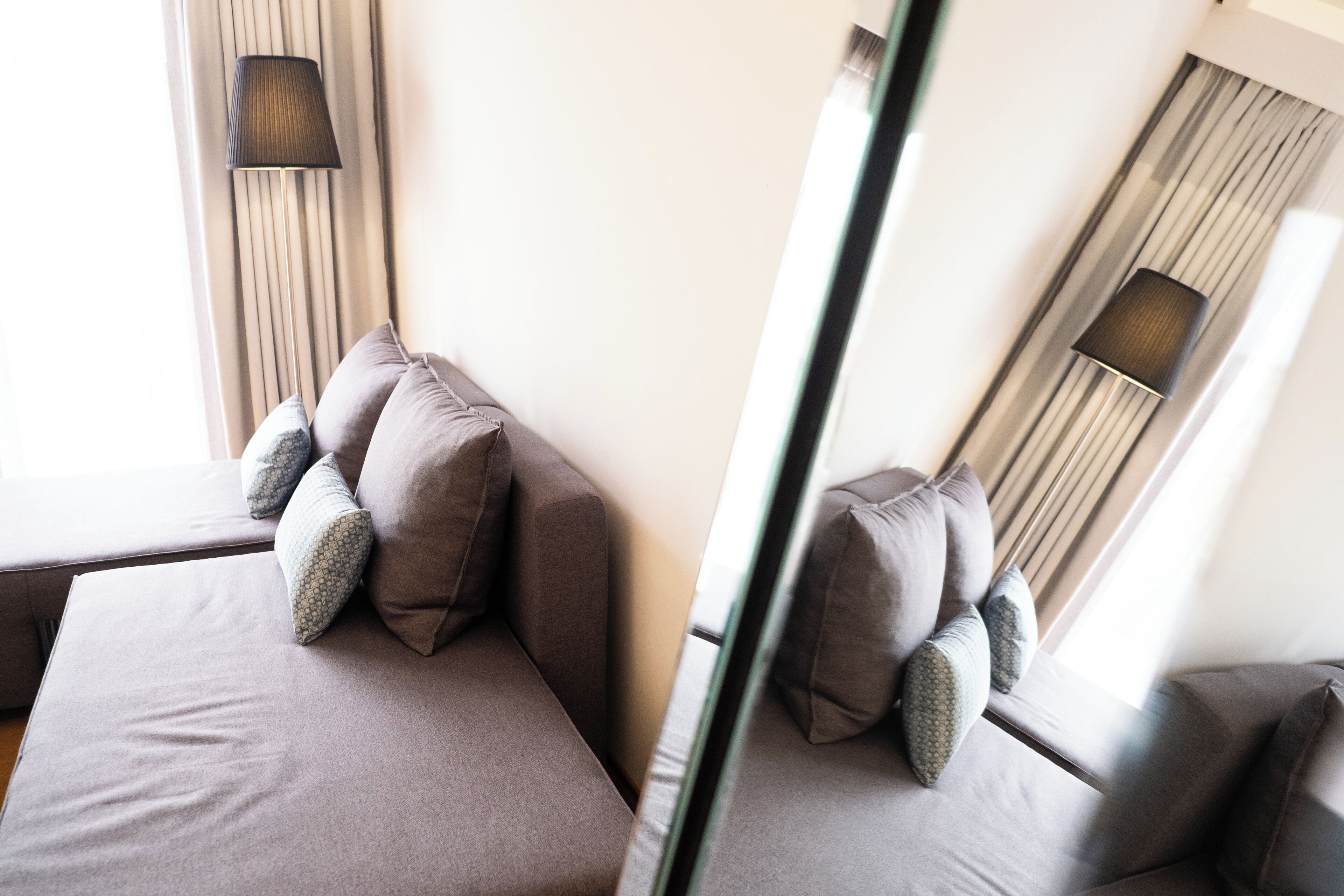 Ein modernes Hotelzimmer mit einem großen Bett, einem Nachttisch und einer Lampe.