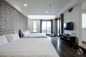 A modern hotel room with two beds, a large window with curtains, a flat-screen TV, and a wooden floor. - Moonlit Seaview B&B (Donghe)