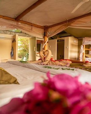 A room with a bed, a wooden ceiling, and a window. - Manyatta Camp (Voi)