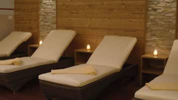 Relax in comfort with three plush chairs, each paired with a small table and a candle.