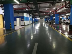 A multi-level parking garage with blue pillars, clear signage, and multiple parking levels. - Dahengqin Superior Talent Hotel (Hengqin Port Branch) (Zhuhai)