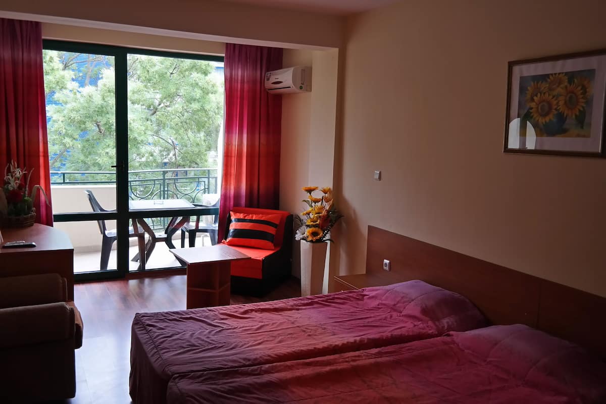 Desk, iron/ironing board, bed sheets