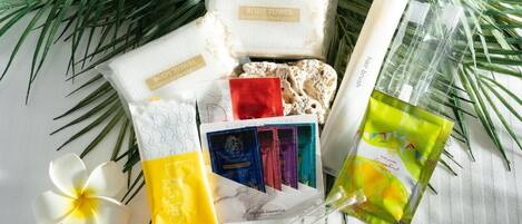 A variety of personal care items including body towels, organic cosmetics, and a face mask.