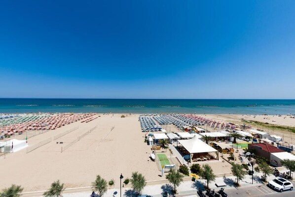 On the beach, white sand, sun loungers, beach umbrellas