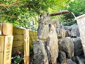 Experience serenity in this traditional Japanese garden, surrounded by lush greenery and a serene wooden structure.