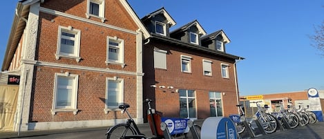 Un edificio de ladrillo con una bicicleta estacionada adelante.