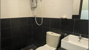 A bathroom with a toilet, a sink, and a shower. -  JQ Suria Hotel (Ipoh)