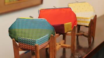 Three hexagonal cushions on wooden chairs.