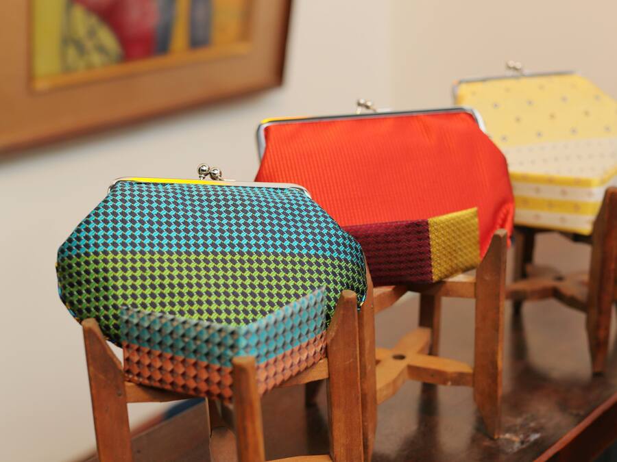 Three hexagonal cushions on wooden chairs.
