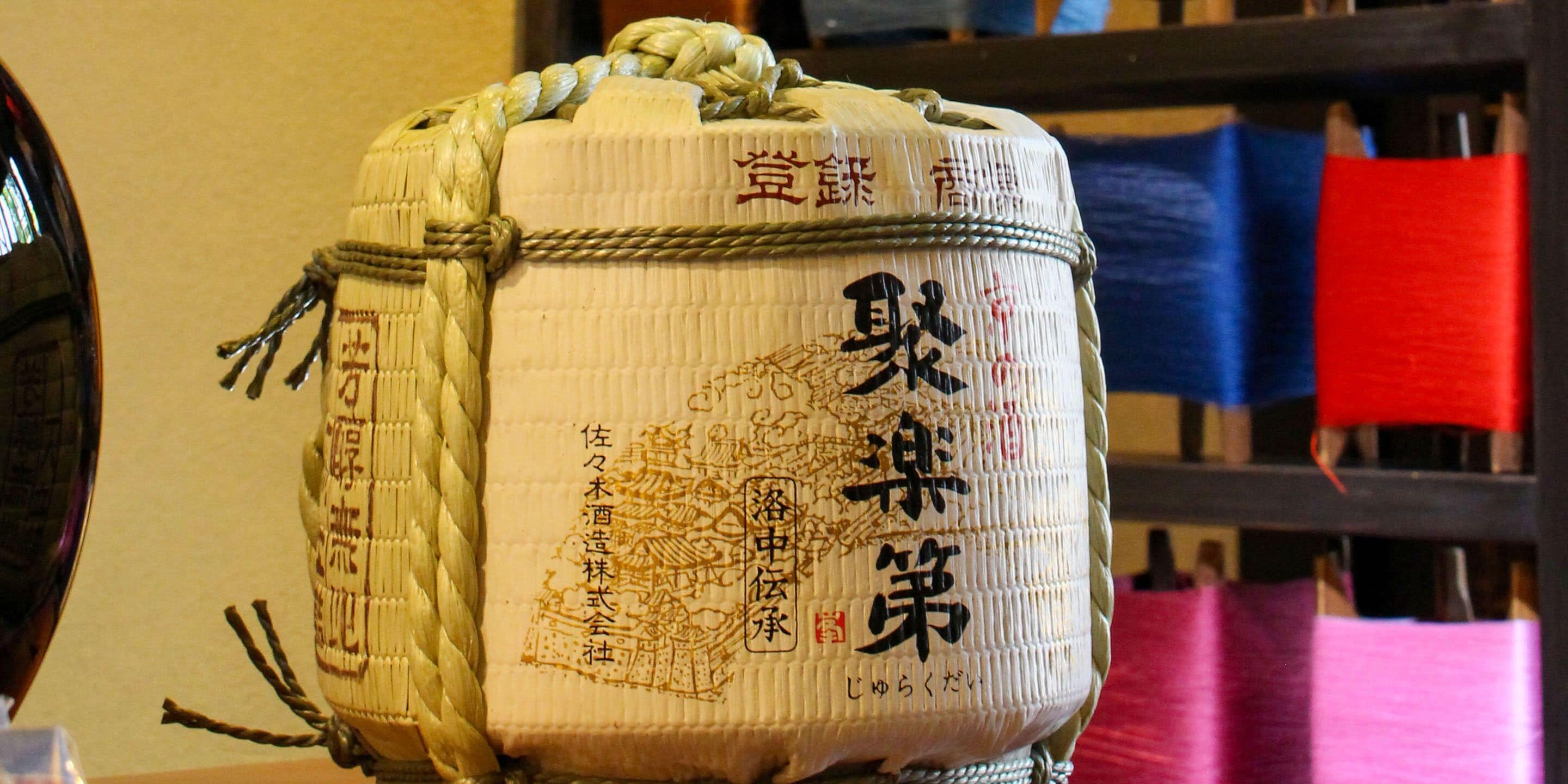 Een traditioneel Japans sakevat met inscripties en een touwgreep.