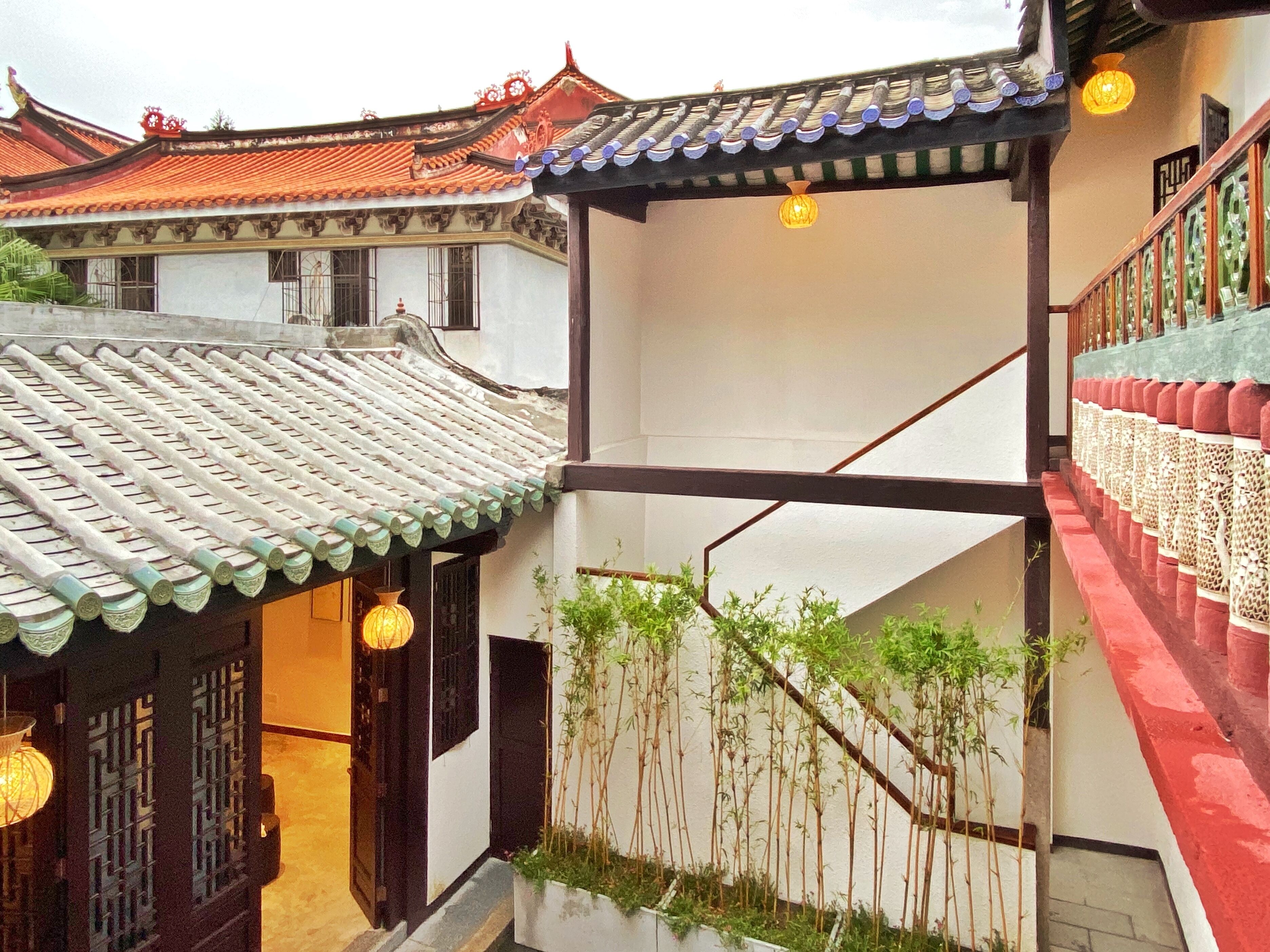 A traditional building with a tiled roof and a staircase with a railing.