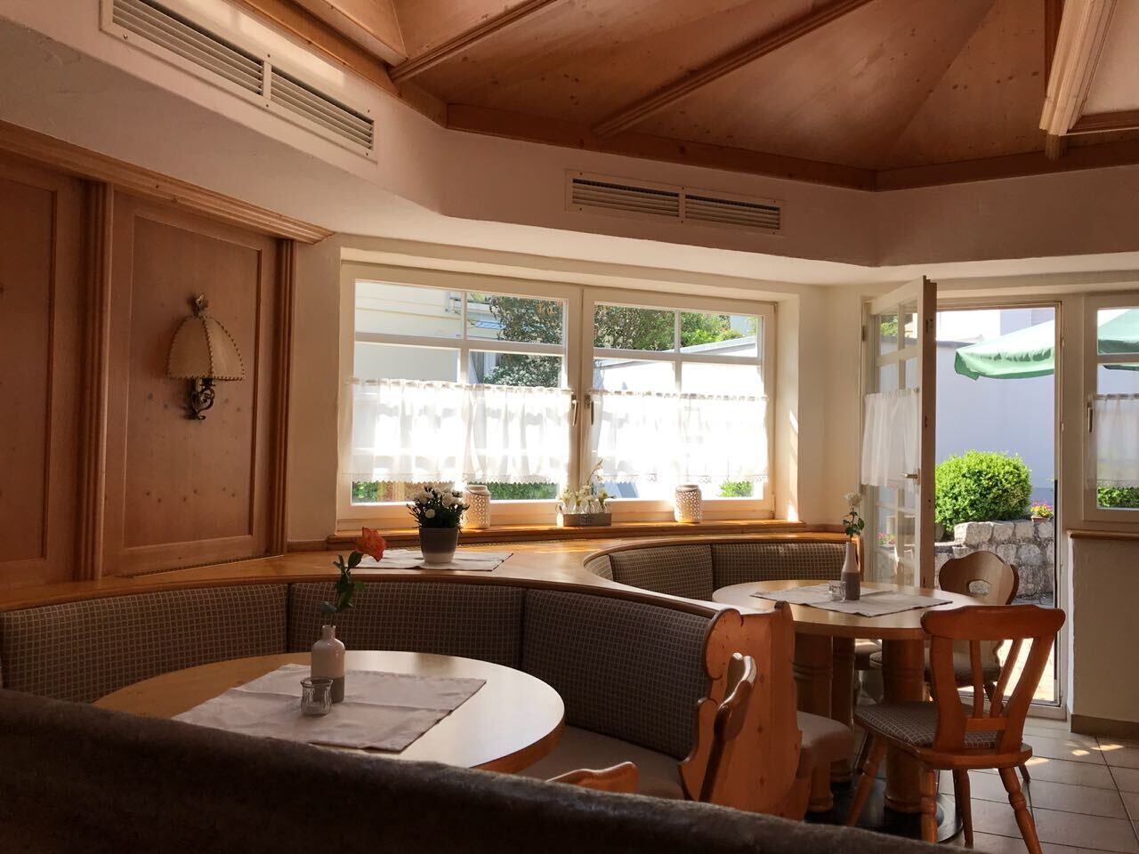 A cozy dining area with a round table, wooden chairs, and a built-in bench.