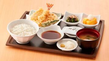 A tray with various Japanese dishes including rice, soup, and tempura.