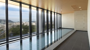 A modern interior with large windows, a tiled floor, and a door. - JR Clement Inn Takamatsu (Takamatsu)