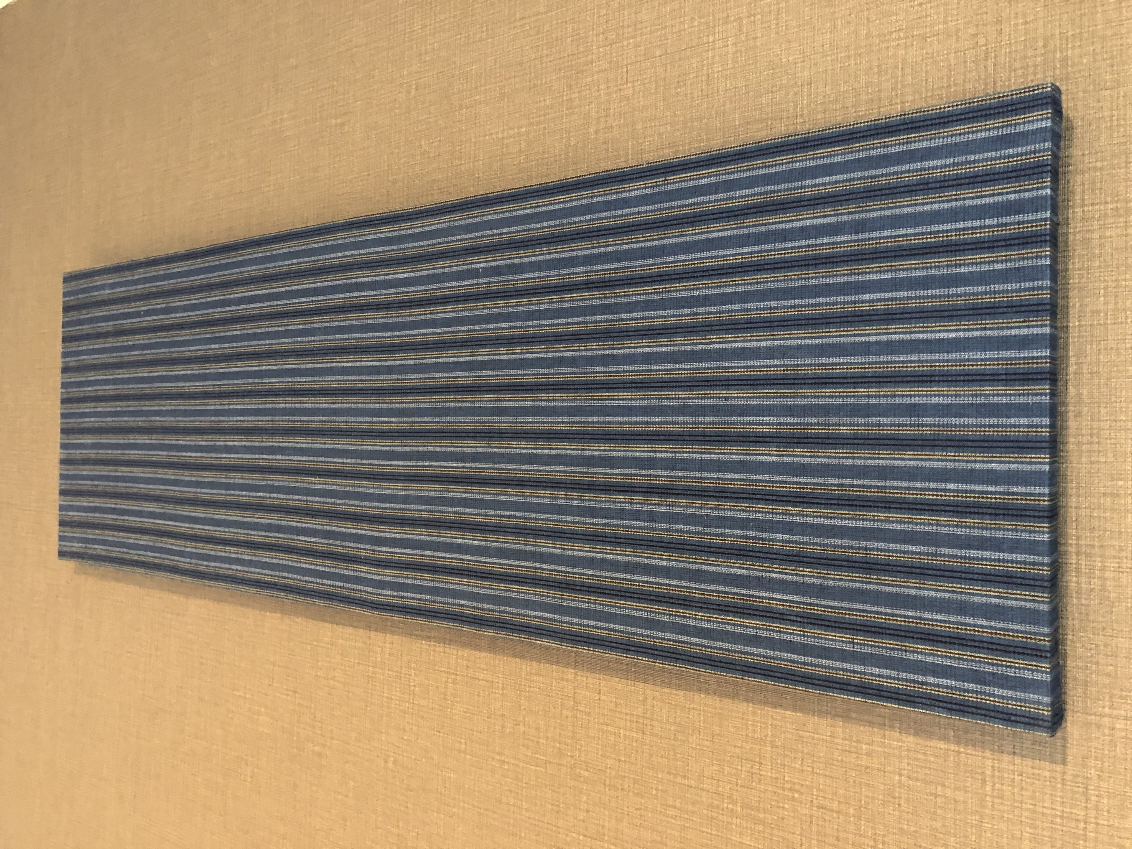 A wall with a textured, striped pattern.