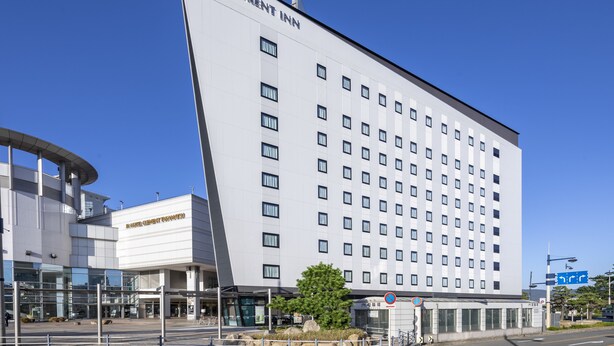 A modern hotel building with a prominent "JR CLEMENT INN" sign, a glass facade, and a clear blue sky. - JR Clement Inn Takamatsu (Takamatsu)