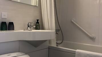 A modern bathroom with a toilet, sink, and shower.