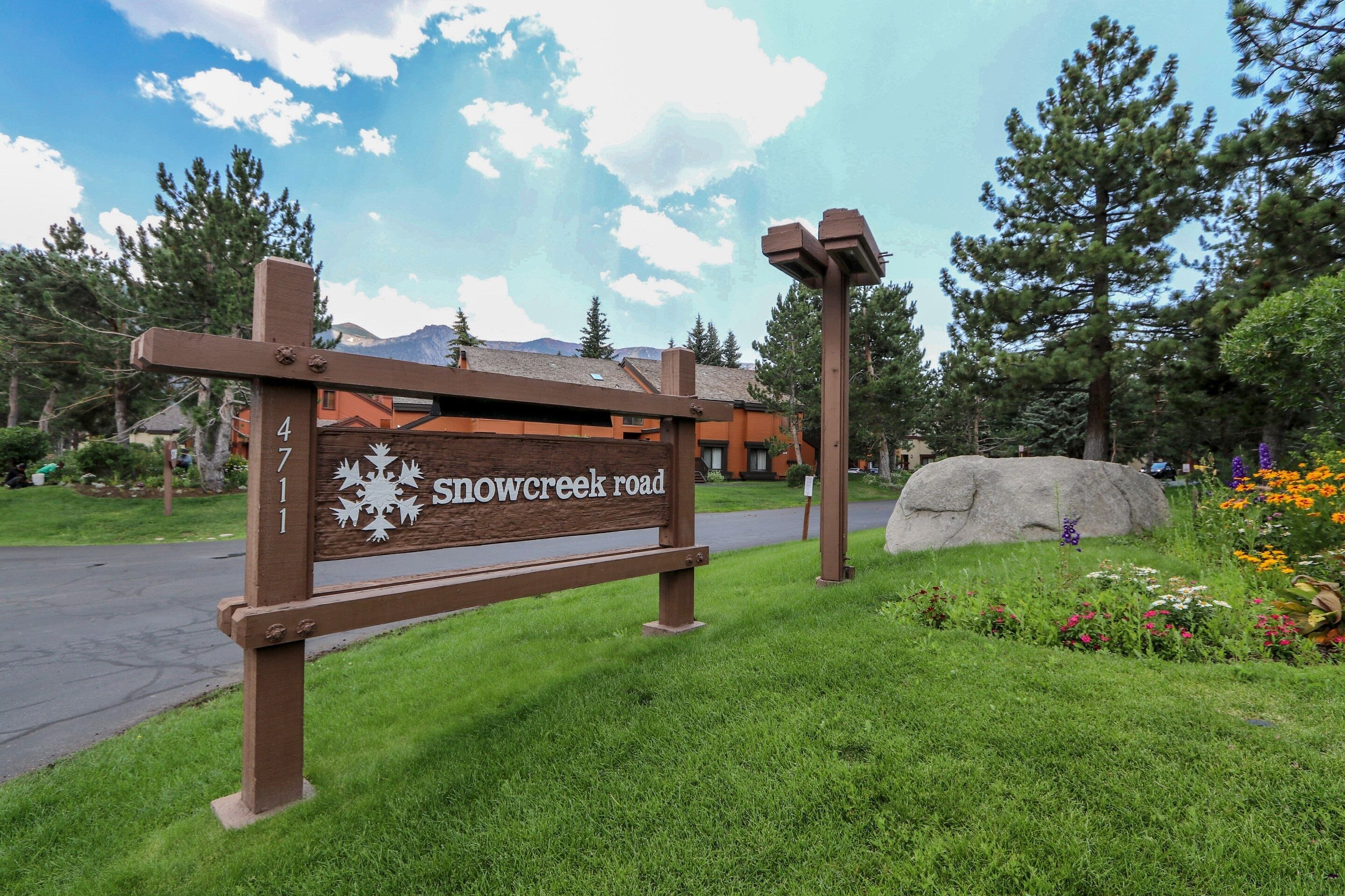 A wooden sign with "Snow Creek Road" and a number "4" indicating a location.