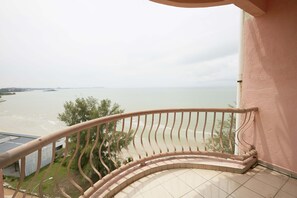 A balcony with a curved railing overlooking a body of water. - JC Sunshine Bay Resort Port Dickson (Port Dickson)