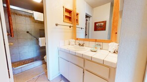 A bathroom with a shower, a sink, and a mirror. - Summit #34 3 Bedroom Condo (Mammoth Lakes)