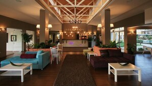 A spacious lobby with a reception desk, multiple seating areas, and large windows. - Blue Orange Beach Resort (Sozopol)