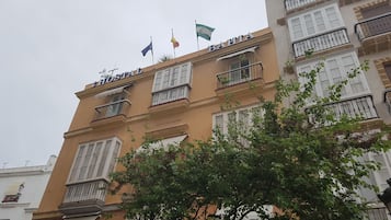 Experience the charm of BAHIA HOSTAL, a traditional hotel with balconies and windows with shutters.