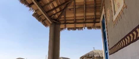 A traditional thatched-roof structure with a simple, open design.