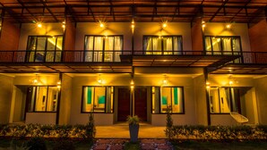 A two-story building with a balcony, a central entrance, and a pathway leading to the door. - SeeSea Resort (La-ngu)