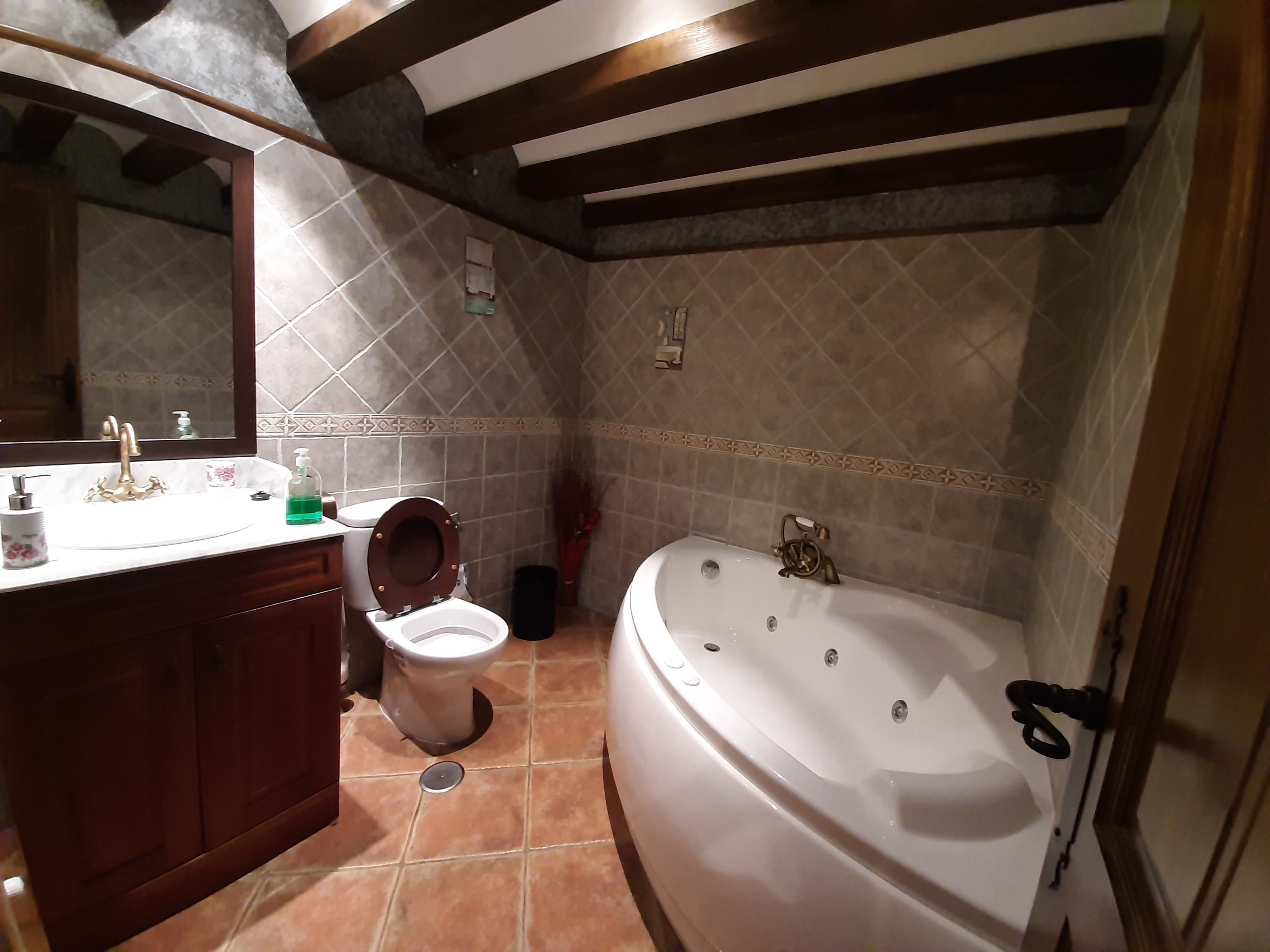 A bathroom with a sink, toilet, and bathtub.