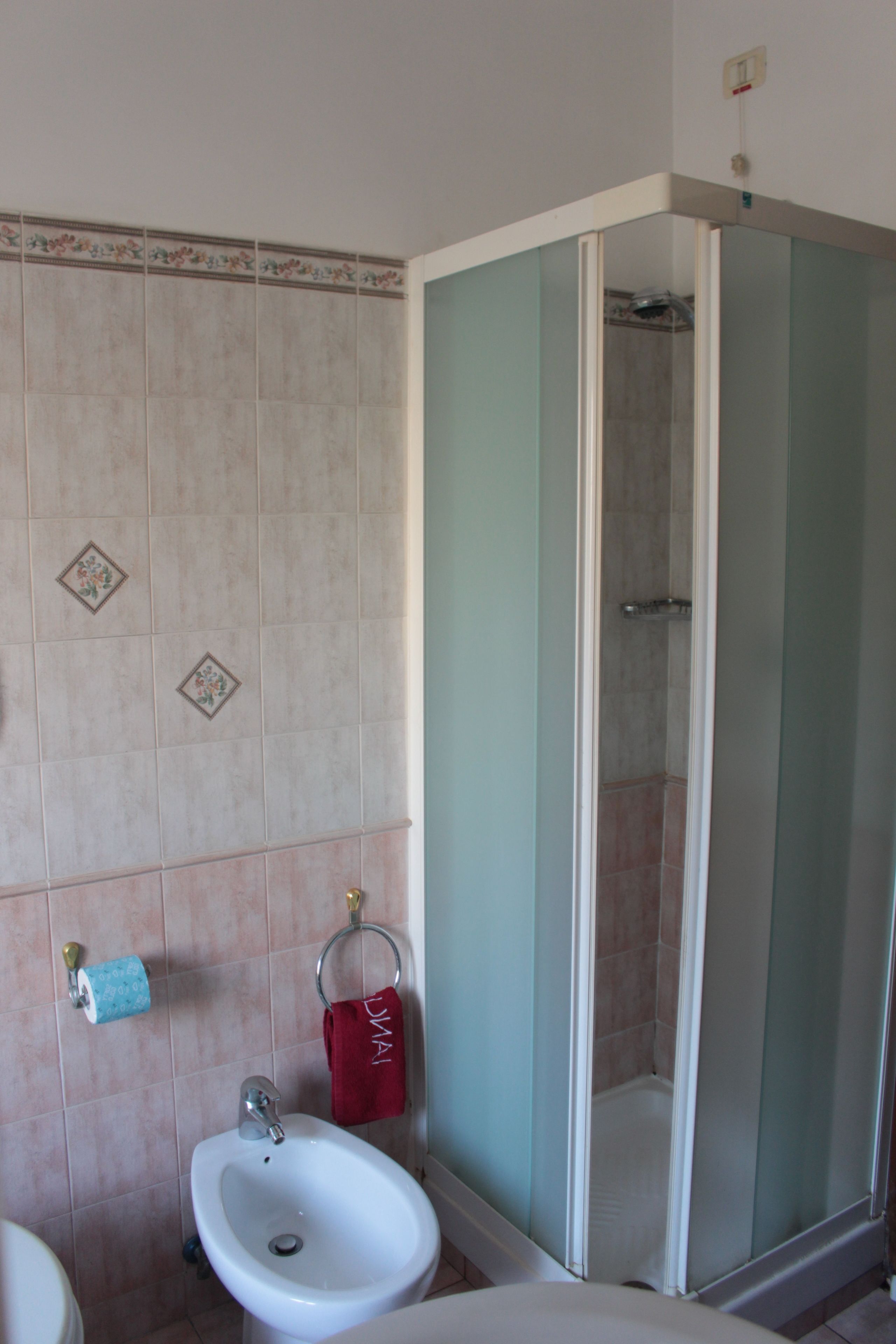 A bathroom with a sink, toilet, and shower.